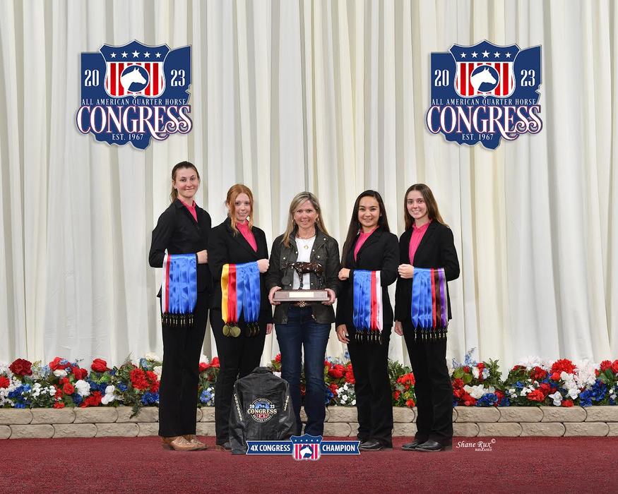 Five people holding ribbons and a trophy at the 2023 All American Quarter Horse Congress