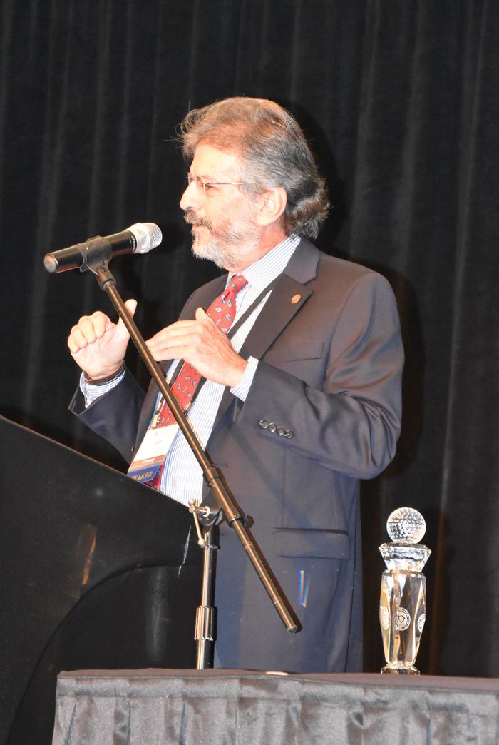 A man giving an award acceptance speech. 