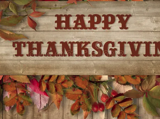 Wooden plank sign reading "HAPPY THANKSGIVING" with autumn leaves and berries.