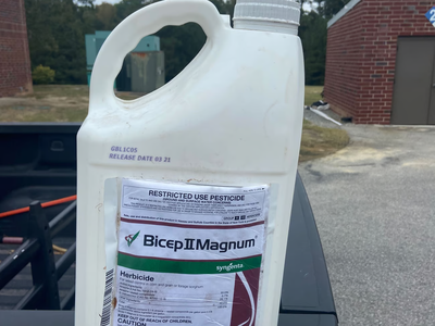 White pesticide bottle on truck tailgate.