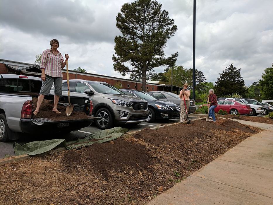 Pollinator garden volunteers prepping a bed for planting. 