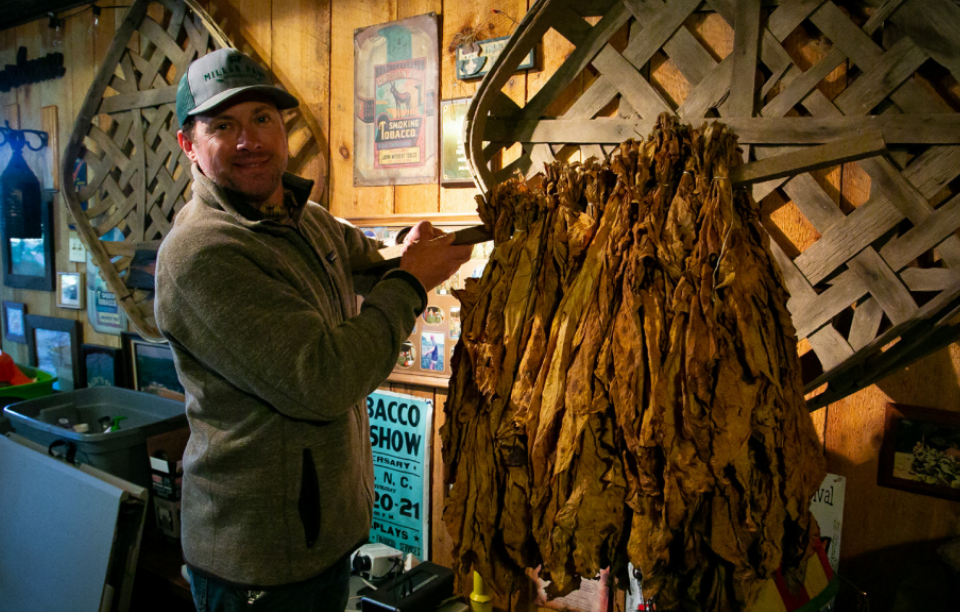 Man leading a tour of a tobacco museum
