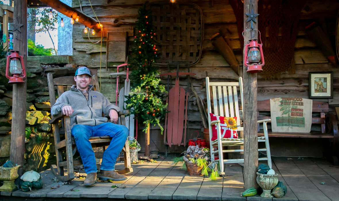 Man sitting in front of family home