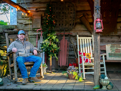 Man sitting in front of family home