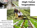 High tunnel with vegetables growing and growers smiling
