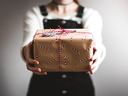 person handing a gift