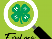 Magnifying glass over green 4-H clover with H on each leaf; word "Explore" below