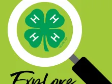 Magnifying glass over green 4-H clover with H on each leaf; word "Explore" below