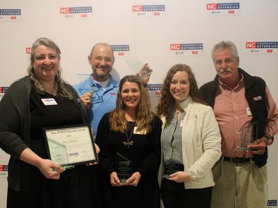 Five award winners pose together.