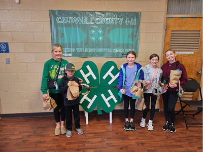 kids posing with crafts