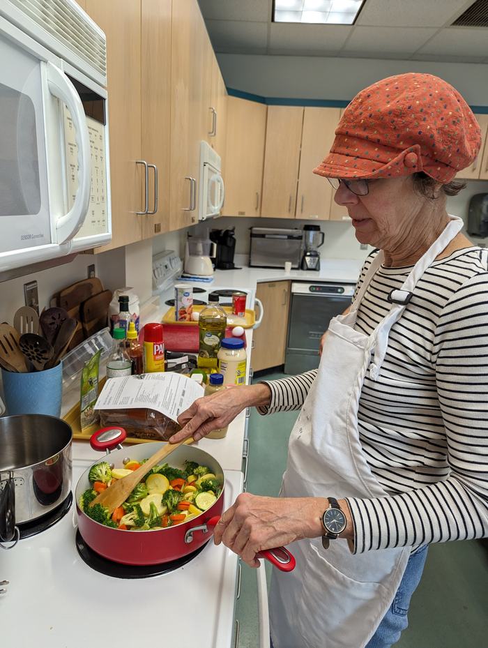 Extension Master Food Volunteer, Lee Harlow from Leland preparing the vegetables.