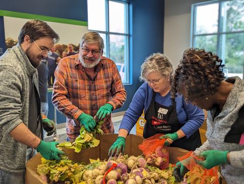 Extension Master Food Volunteers working together to pack turnips at the food bank.