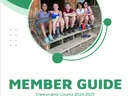 Five teens sitting on wooden steps; cover text "MEMBER GUIDE Transylvania County 2024-2025" and 4-H clover