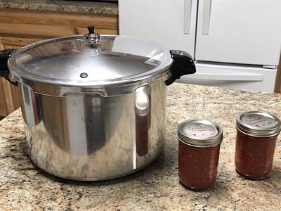 canner on counter with two jars