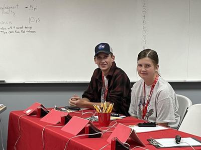 Students at a quizbowl table.