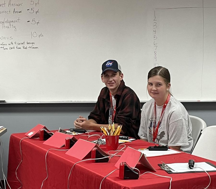 Students at a quizbowl table.