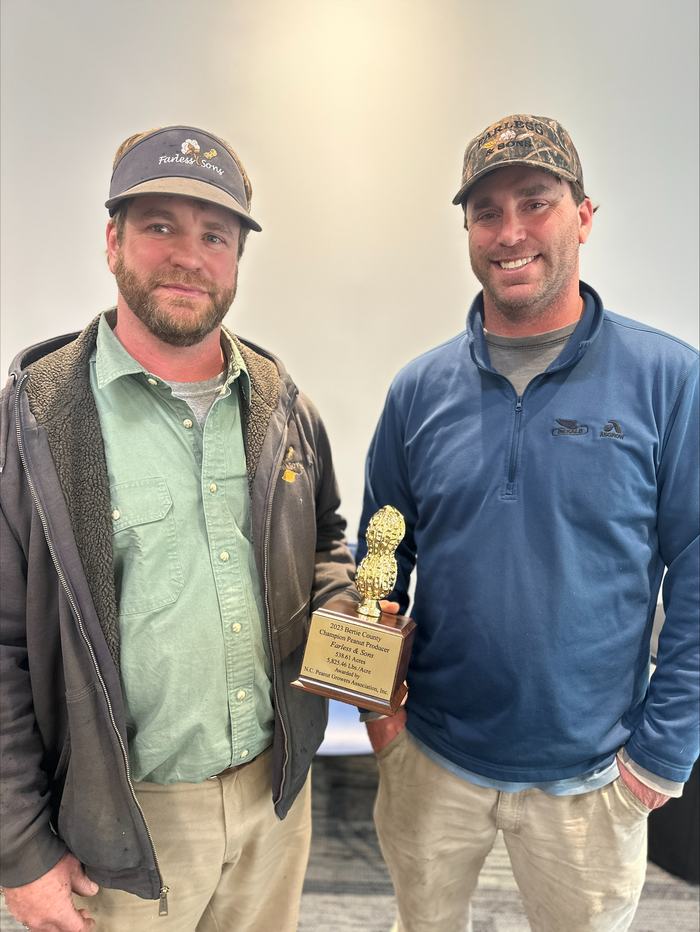 A man presented with a peanut trophy.