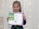 Abbigail Mullis receiving her award for submitting two Cloverbud Record Books