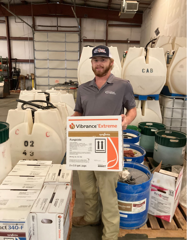 A man holding a box of pesticide.