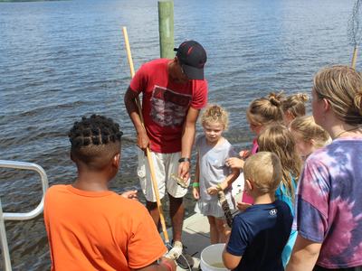 group of children looking a crab