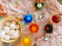 A child paints eggs.