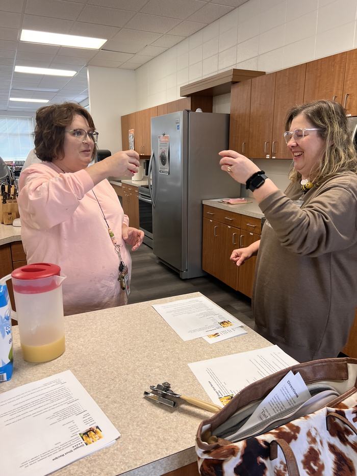 Two women cheers a health shot.