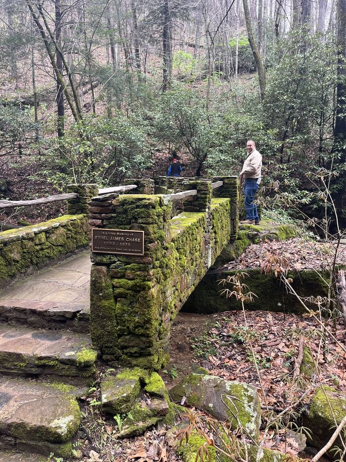 A stone bridge crossing a small stream.
