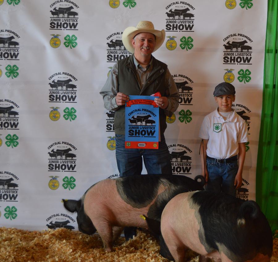 Boy showing pig