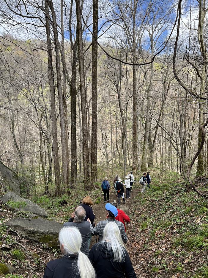 People hike down the side of a mountain.