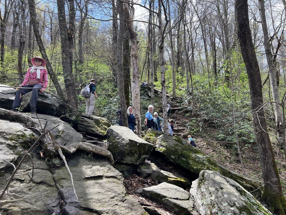 Hikers sitting on a rocky bluff.