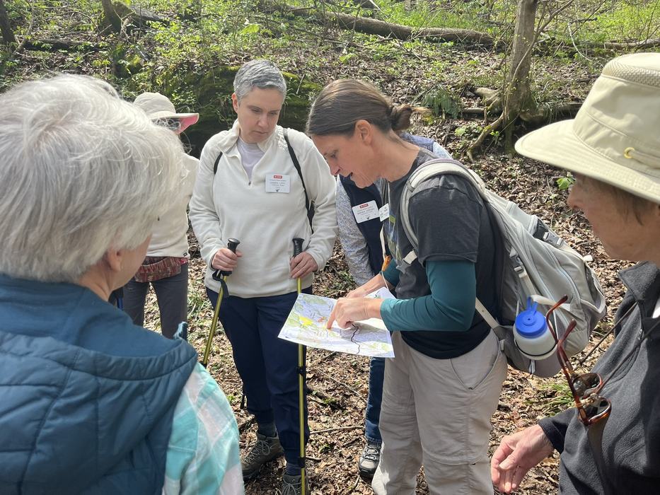 Hikers inspect a trailmap.