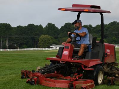 Marty Parrish mowing plots at the NC State University Lake Wheeler Turfgrass Research Lab.