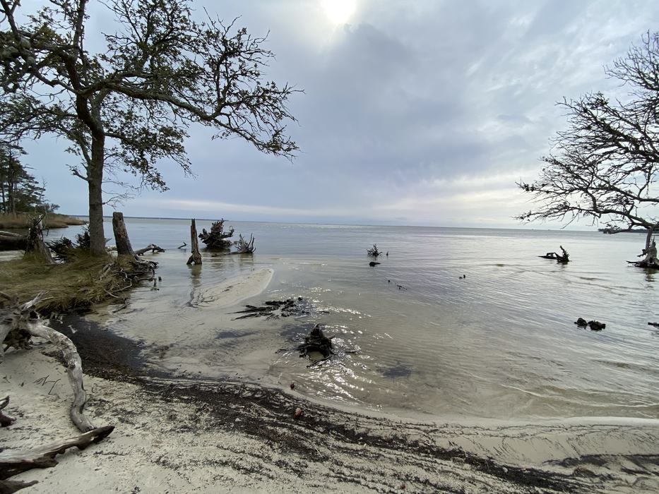 A beach and a view of the Roanoke Sound.