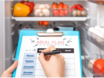 Looking in refrigerator to determine what to add to a grocery list.
