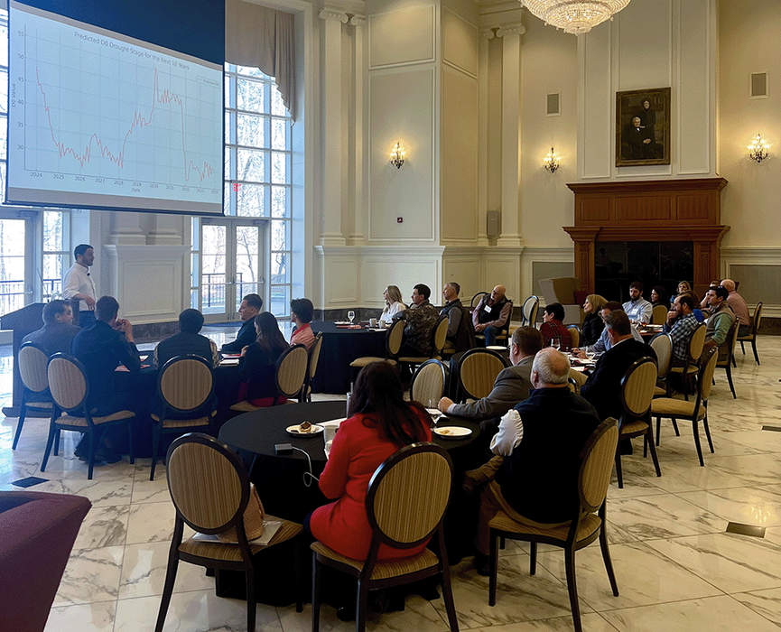 People in a conference room listen to a talk.