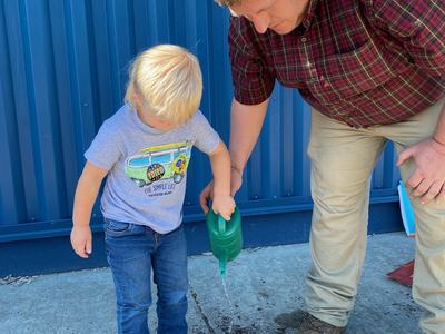 student watering plants