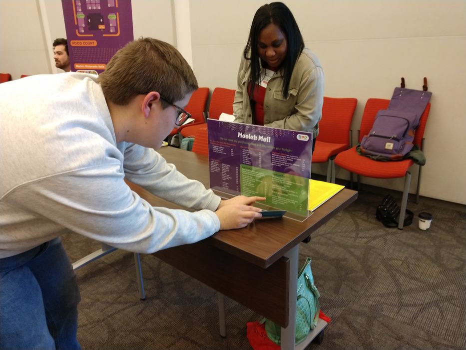 Two people look at a display.