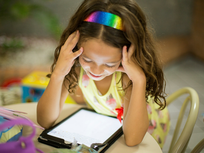 young girl looking at a tablet