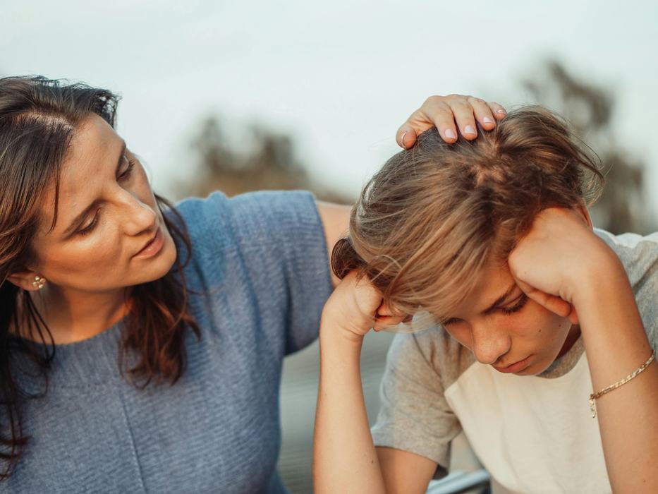 mother talking to upset boy