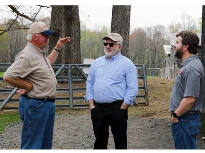 Three men talking on a farm