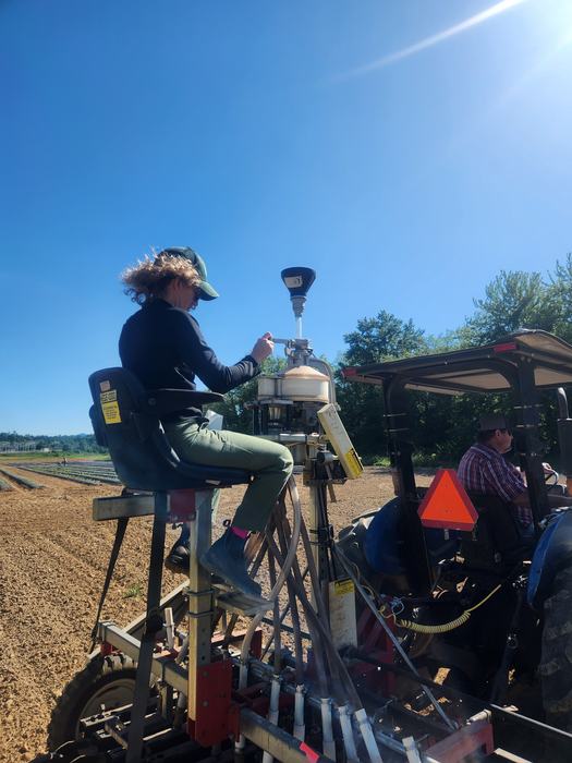 woman on grain drill planting hemp seeds