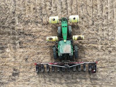 tractor in field with planter attached