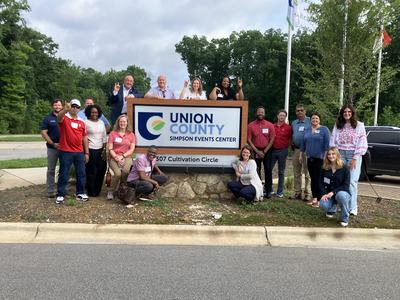 Group of participants in front of Simpson Event Center sign
