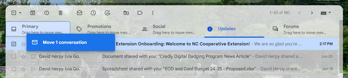 A screenshot of an inbox shows an email being dragged from the Updates tab to the Primary inbox tab. 