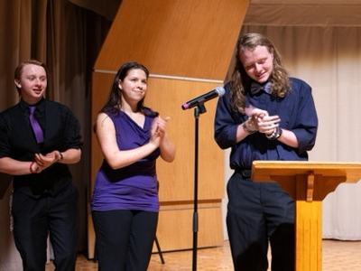 On the far left, Malachi Schwartz West District Vice President, and member of Caldwell County 4-H presents awards at the 2024 4-H West District Activity Day with his fellow district officers.