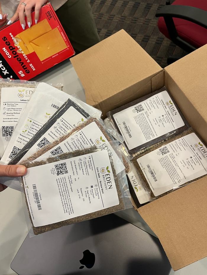 Packets of seed in a cardboard box.