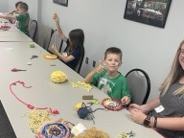 kid holding up a dream catcher he made