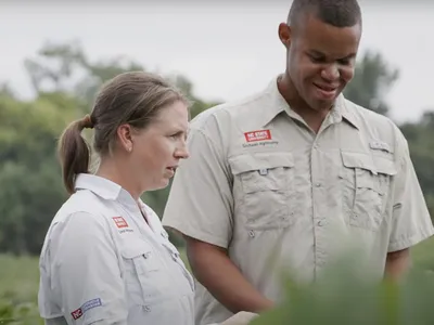 two NC State Extension Agents working in the Field