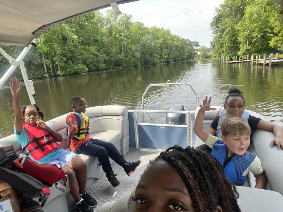 Students ride a boat on a river.