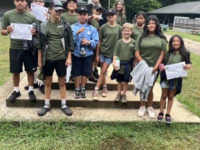 Children and Teenage campers pose together.
